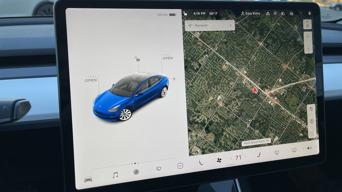 Photo: the centre touchscreen of a Tesla Model 3 showing the car on the left and a satellite map with a Navigate box on the right